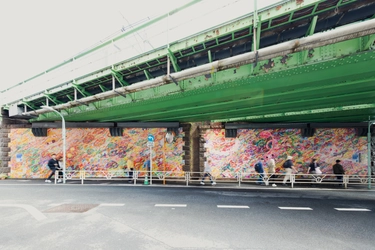 JR代々木駅付近にロッカクアヤコの大型壁画が完成！ 災害時の一時退避場所を広めるため、 幅合計約50メートルにも及ぶパブリックピースが公開。