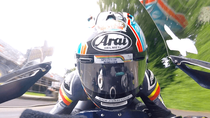 疾走するライダーのすぐ脇には民家